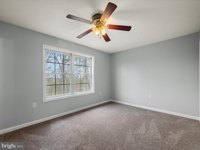 spare room with baseboards, carpet flooring, and a ceiling fan