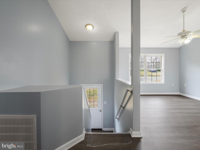 foyer entrance with visible vents, wood finished floors, baseboards, and ceiling fan