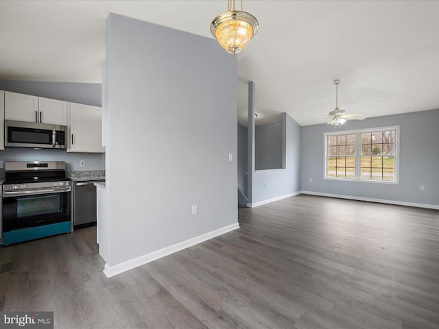 interior space with dark wood finished floors, baseboards, lofted ceiling, and ceiling fan