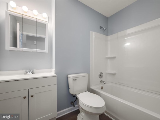 bathroom featuring toilet, vanity, and tub / shower combination