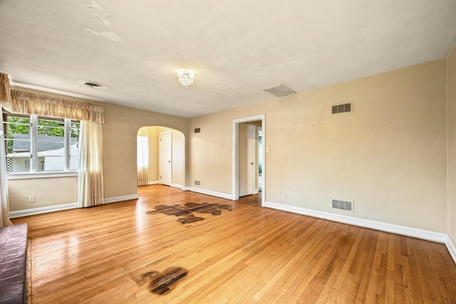 1435 Bluestone St, Harrisonburg, VA 22801 - empty room with arched walkways, baseboards, and light wood-type flooring