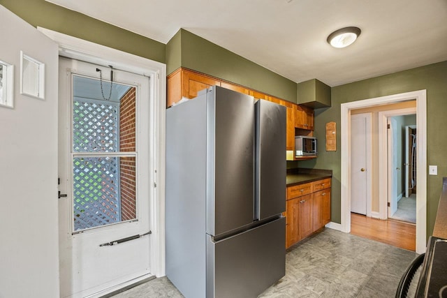 1435 Bluestone St, Harrisonburg, VA 22801 - kitchen featuring stainless steel appliances, brown cabinets, dark countertops, and baseboards