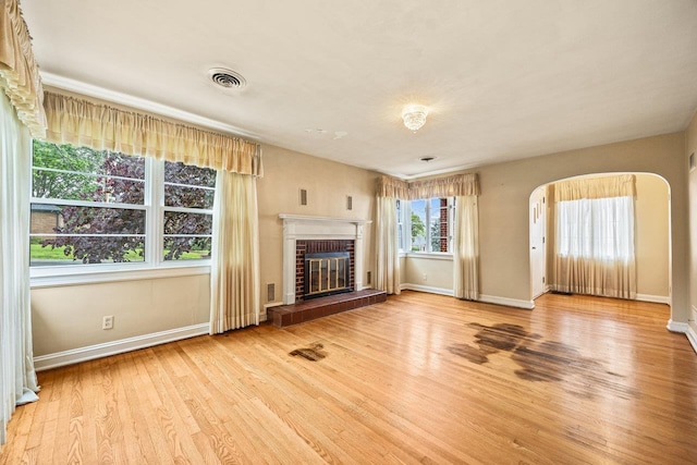 1435 Bluestone St, Harrisonburg, VA 22801 - unfurnished living room featuring a fireplace, wood finished floors, baseboards, and arched walkways
