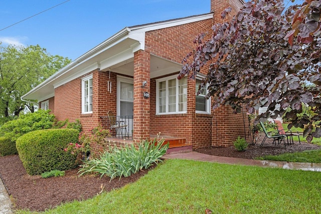 1435 Bluestone St, Harrisonburg, VA 22801 - view of front facade with brick siding, a front lawn, and a chimney