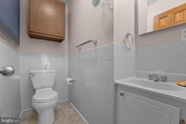 12400 Constitution Hwy, Orange, VA 22960 - bathroom with tile walls, toilet, wainscoting, vanity, and tile patterned flooring