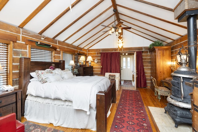 2665 Deerfield Valley Rd, Deerfield, VA 24432 - bedroom featuring beamed ceiling, a wood stove, wood walls, and wood-type flooring