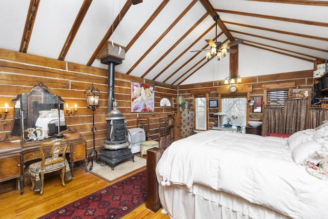 2665 Deerfield Valley Rd, Deerfield, VA 24432 - bedroom with wooden walls, high vaulted ceiling, a wood stove, and wood finished floors