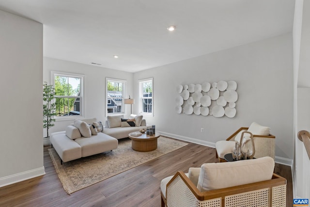 living area with wood finished floors, baseboards, and recessed lighting
