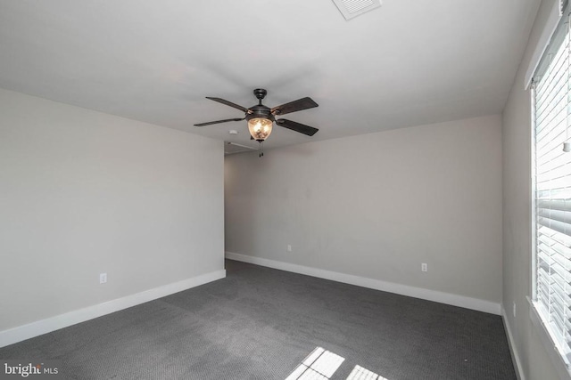 empty room with a ceiling fan, carpet flooring, and baseboards