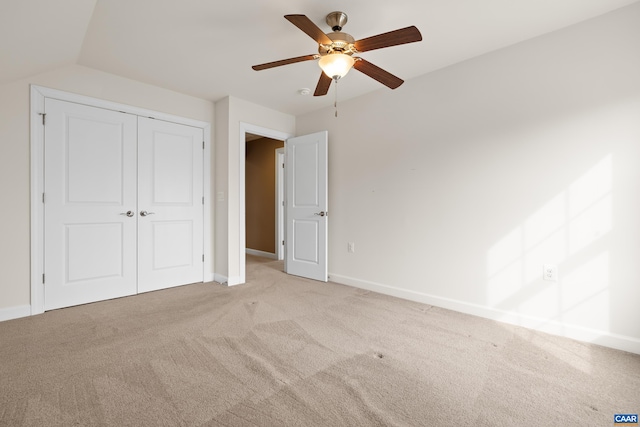 unfurnished bedroom featuring baseboards, carpet flooring, a closet, and ceiling fan