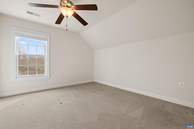 additional living space featuring carpet, visible vents, baseboards, and lofted ceiling