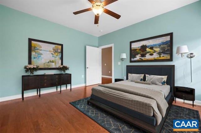 bedroom featuring baseboards, a ceiling fan, and wood finished floors