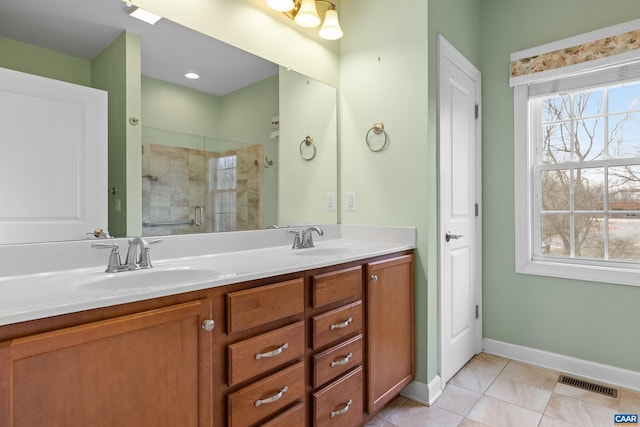 bathroom featuring a shower stall, visible vents, a sink, and double vanity