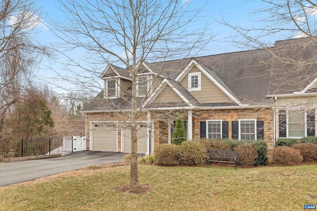 view of front facade featuring a front lawn, driveway, fence, and a garage