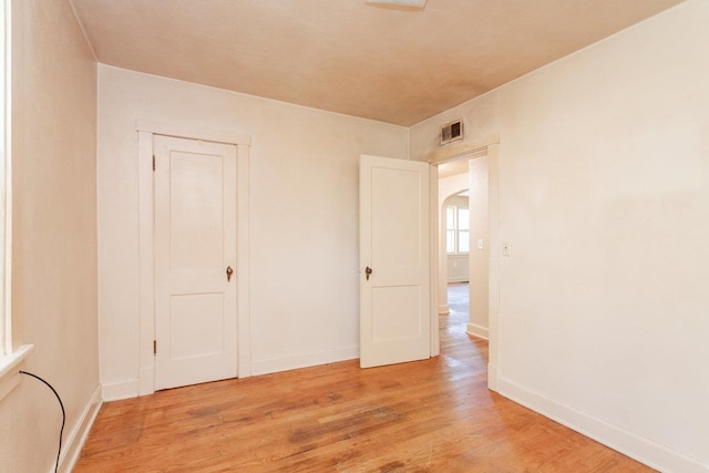 530 Water St W, Harrisonburg, VA 22801 - empty room with light wood-style flooring, baseboards, and arched walkways