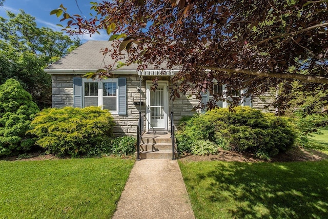 530 Water St W, Harrisonburg, VA 22801 - view of front facade featuring stone siding, a front lawn, and roof with shingles