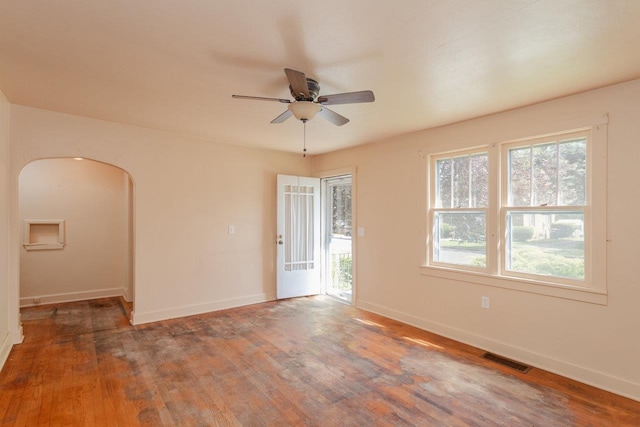 530 Water St W, Harrisonburg, VA 22801 - empty room featuring arched walkways, ceiling fan, wood finished floors, and baseboards