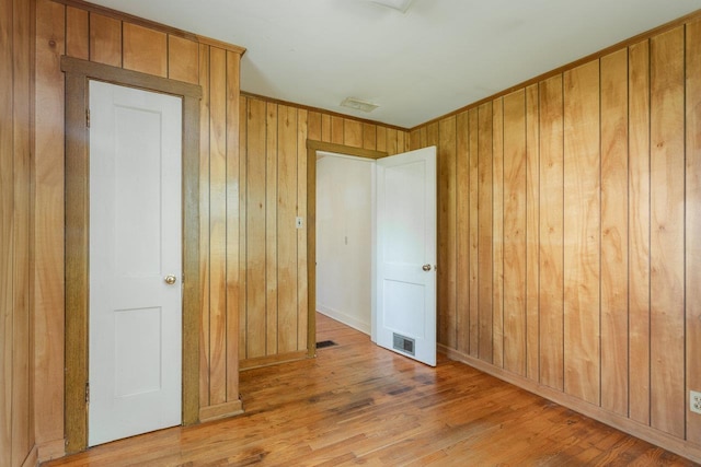 530 Water St W, Harrisonburg, VA 22801 - empty room featuring wood walls, light wood-style floors, baseboards, and ornamental molding