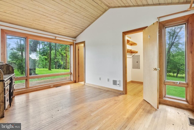  - spare room featuring lofted ceiling, wood ceiling, light wood-type flooring, and electric panel