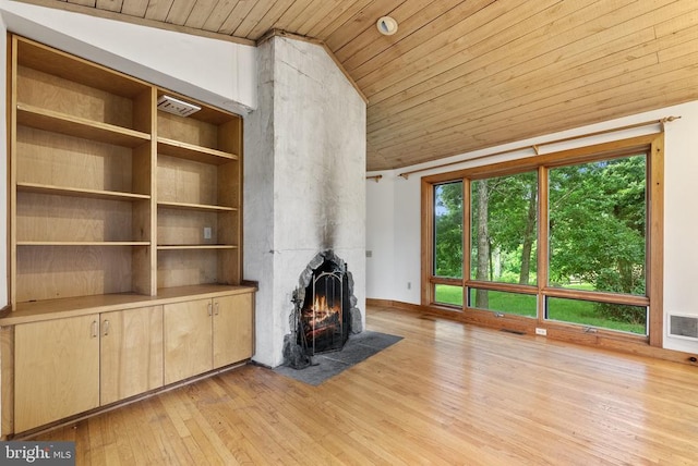  - unfurnished living room featuring wooden ceiling, light wood-style floors, lofted ceiling, and a large fireplace