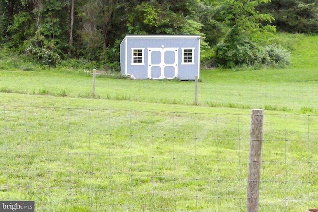 view of yard featuring a shed and an outbuilding