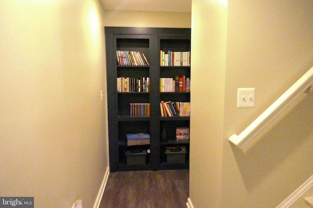 hall with dark wood-style floors and baseboards