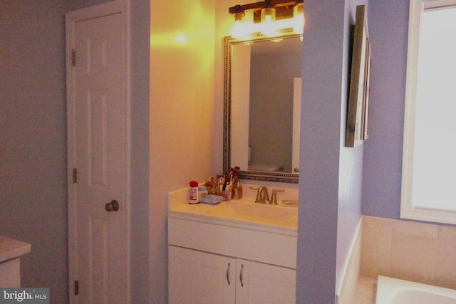 full bath featuring vanity and a bath