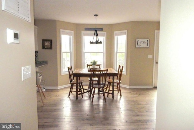 dining area with hardwood / wood-style floors and baseboards