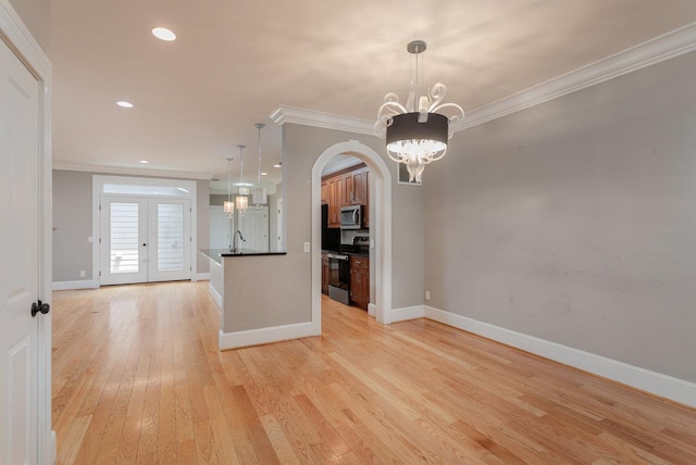 3277 Preston Shore Dr, Rockingham, VA 22801 - empty room with crown molding, light wood-style floors, a chandelier, arched walkways, and recessed lighting