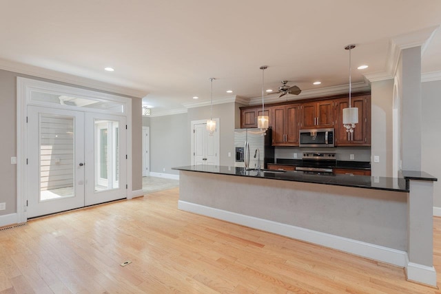 3277 Preston Shore Dr, Rockingham, VA 22801 - kitchen featuring stainless steel appliances, dark countertops, ornamental molding, light wood finished floors, and pendant lighting