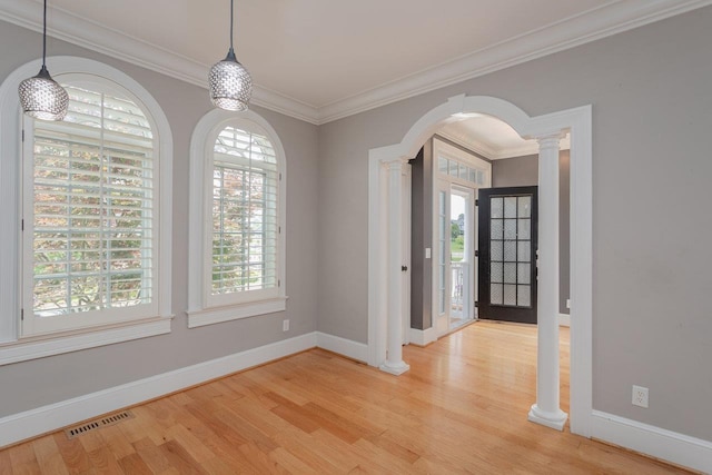 3277 Preston Shore Dr, Rockingham, VA 22801 - foyer featuring plenty of natural light, light wood-type flooring, arched walkways, crown molding, and decorative columns