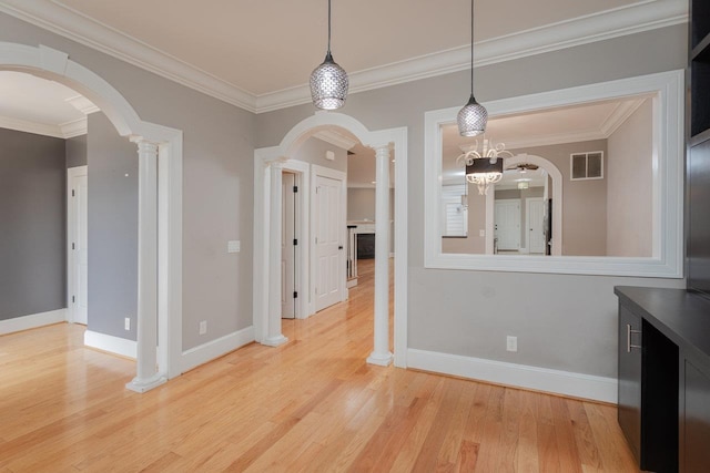 3277 Preston Shore Dr, Rockingham, VA 22801 - unfurnished dining area featuring ornate columns, arched walkways, light wood-type flooring, crown molding, and a chandelier