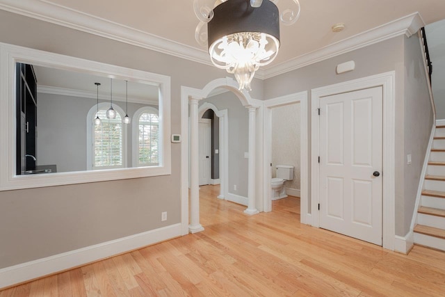 3277 Preston Shore Dr, Rockingham, VA 22801 - unfurnished dining area with arched walkways, ornamental molding, wood finished floors, a chandelier, and stairway