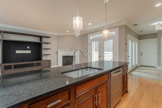 3277 Preston Shore Dr, Rockingham, VA 22801 - kitchen with dishwasher, brown cabinetry, light wood-style floors, decorative light fixtures, and a fireplace
