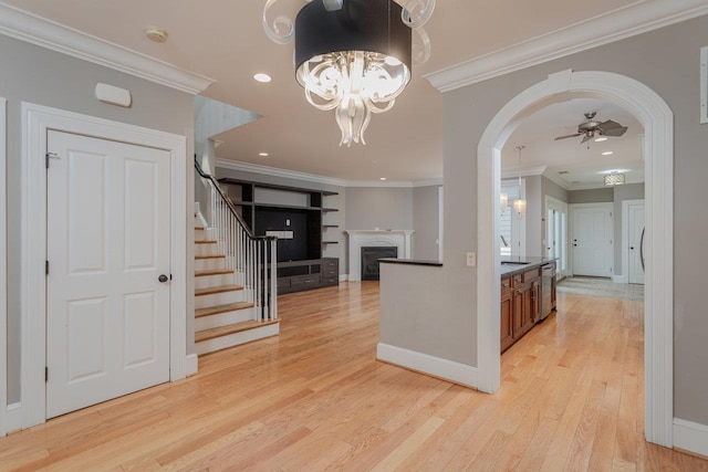 3277 Preston Shore Dr, Rockingham, VA 22801 - kitchen featuring stainless steel dishwasher, light wood finished floors, dark countertops, a fireplace, and ornamental molding