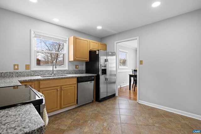 kitchen featuring a wealth of natural light, stainless steel appliances, recessed lighting, and a sink