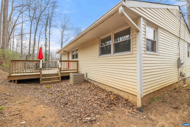 view of home's exterior with a deck and central AC