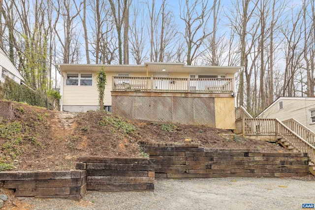 view of front of home featuring stairs and a deck
