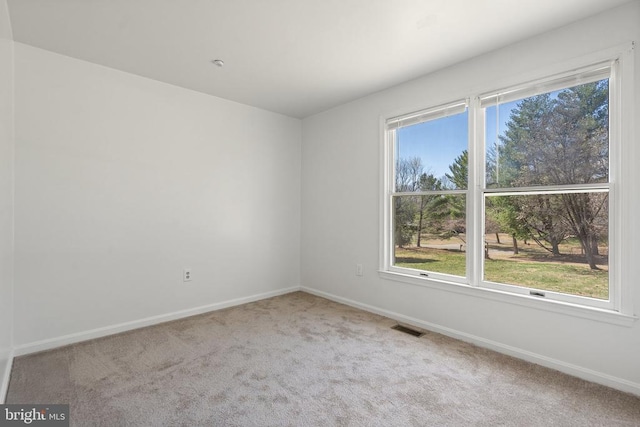 carpeted spare room with baseboards
