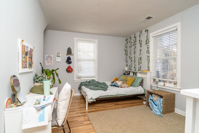 212 Shamrock Rd, Charlottesville, VA 22903 - bedroom with multiple windows, visible vents, wood finished floors, and baseboards