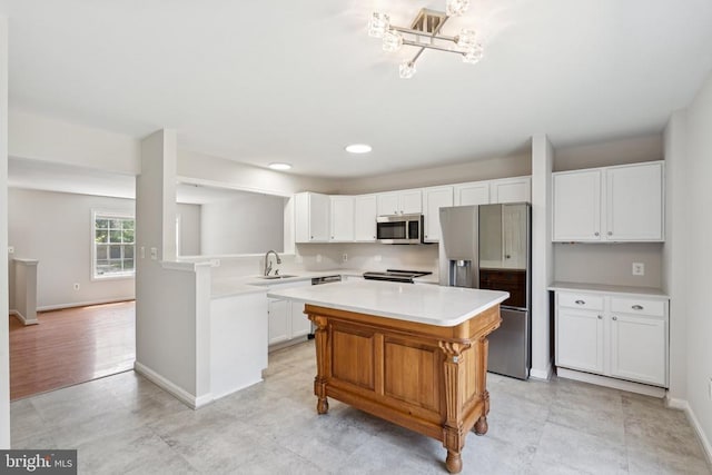 546 Highland Towne Ln, Warrenton, VA 20186 - kitchen featuring stainless steel appliances, light countertops, a kitchen island, white cabinets, and recessed lighting