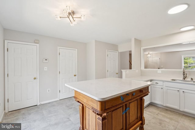 546 Highland Towne Ln, Warrenton, VA 20186 - kitchen with light countertops, white cabinets, and a kitchen island