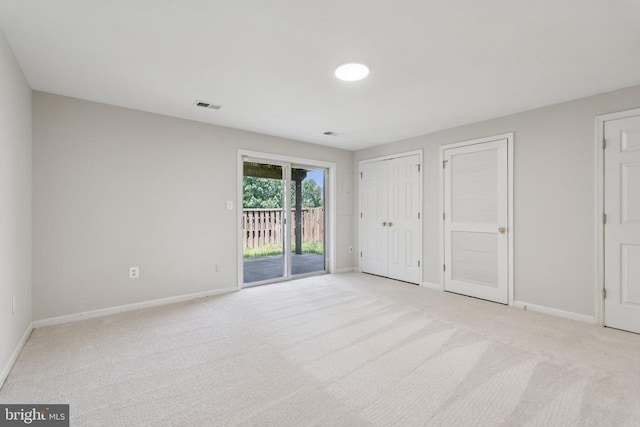 546 Highland Towne Ln, Warrenton, VA 20186 - unfurnished bedroom featuring access to outside, light carpet, and two closets