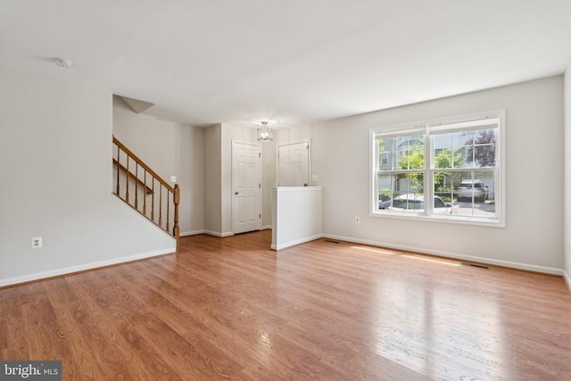 546 Highland Towne Ln, Warrenton, VA 20186 - unfurnished living room featuring wood finished floors and stairway