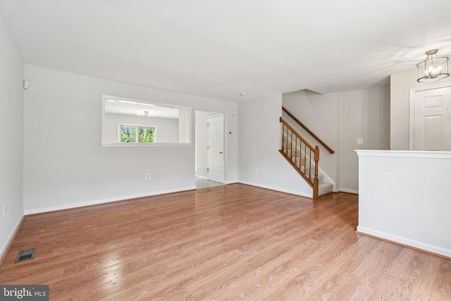 546 Highland Towne Ln, Warrenton, VA 20186 - unfurnished room with wood finished floors, a chandelier, and stairs