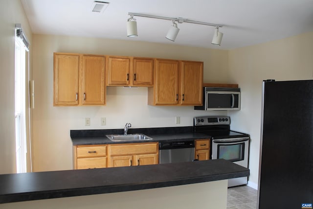 1313 Villa Way Unit F, Charlottesville, VA 22903 - kitchen with a sink, rail lighting, visible vents, dark countertops, and appliances with stainless steel finishes