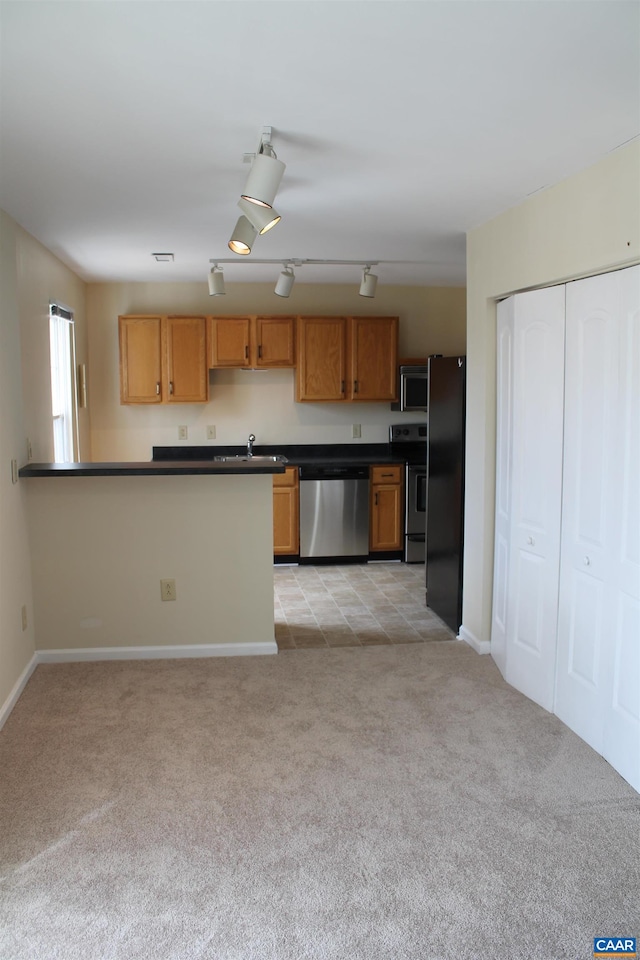1313 Villa Way Unit F, Charlottesville, VA 22903 - kitchen with light colored carpet, baseboards, dark countertops, and appliances with stainless steel finishes