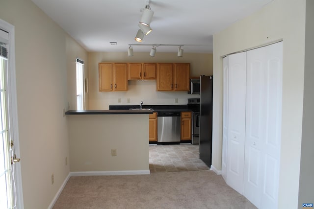 1313 Villa Way Unit F, Charlottesville, VA 22903 - kitchen with a sink, dark countertops, baseboards, light colored carpet, and appliances with stainless steel finishes