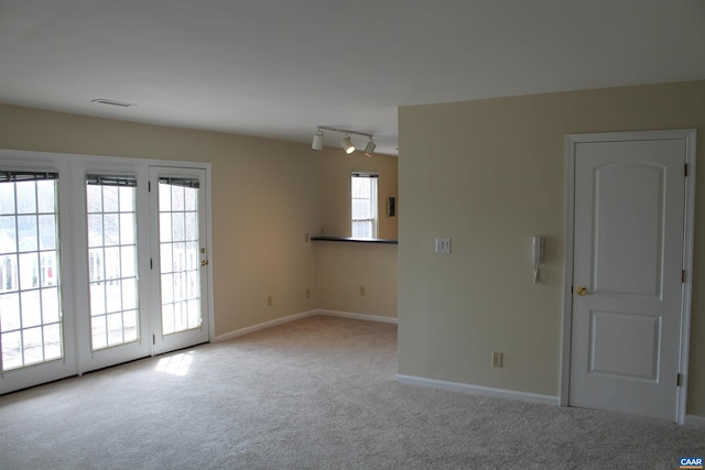 1313 Villa Way Unit F, Charlottesville, VA 22903 - spare room featuring baseboards, visible vents, carpet, and track lighting