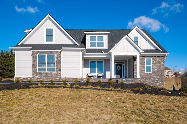 view of front of property featuring covered porch, a front lawn, and board and batten siding